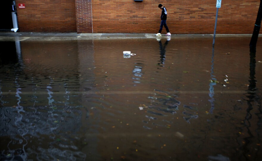 A resident traverses flooded streets as cleanup operations begin in Hoboken, N.J. The storm surge triggered deep flooding in low-lying neighborhoods.