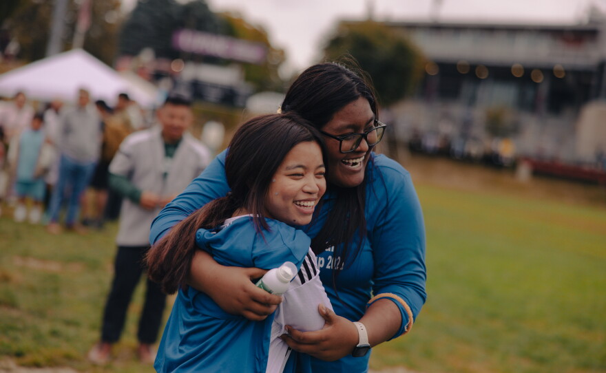 Volunteers and friends Reena Pradhan and Jenny Gurung, both helping ARU's Soccer for Success program, hang out on the sidelines of the Kalu Singh Tamang Memorial Championship in Harrisburg, Pa., on Sept. 21, 2025.