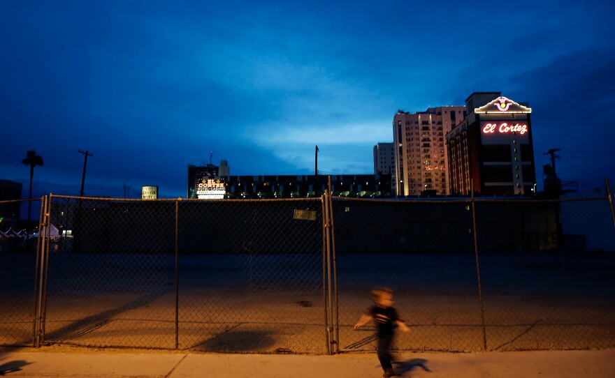 A child runs past an empty lot en route to evening events at the Container Park.