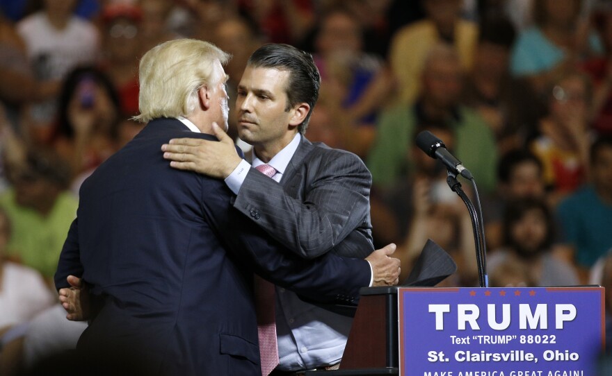 Donald Trump Jr. hugs his father, Donald Trump, during a campaign rally in Ohio, weeks after Trump Jr. met with a Russian lawyer, as he sought dirt against Democrat Hillary Clinton.