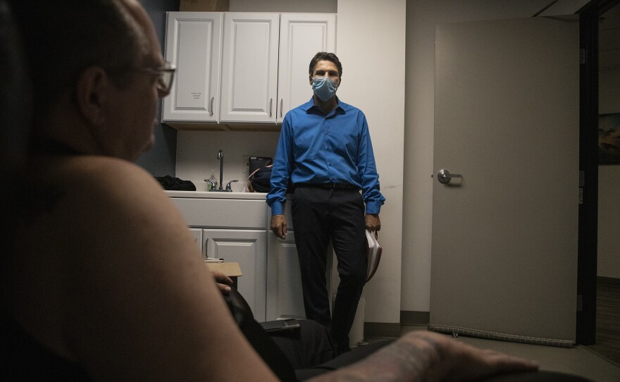 Dr. David Feifel talks with Navy veteran Larry McMinn after a ketamine treatment at the Kadima Neuropsychiatry Institute on May 15, 2020.