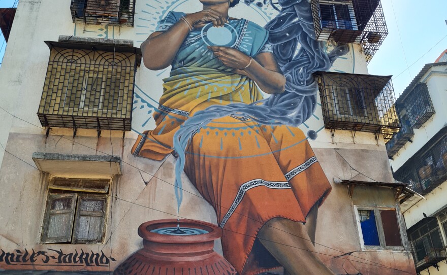 Murals on the sides of buildings near Dharavi, Mumbai's biggest slum, where social workers hold workshops to educate women about sexual violence and consent.
