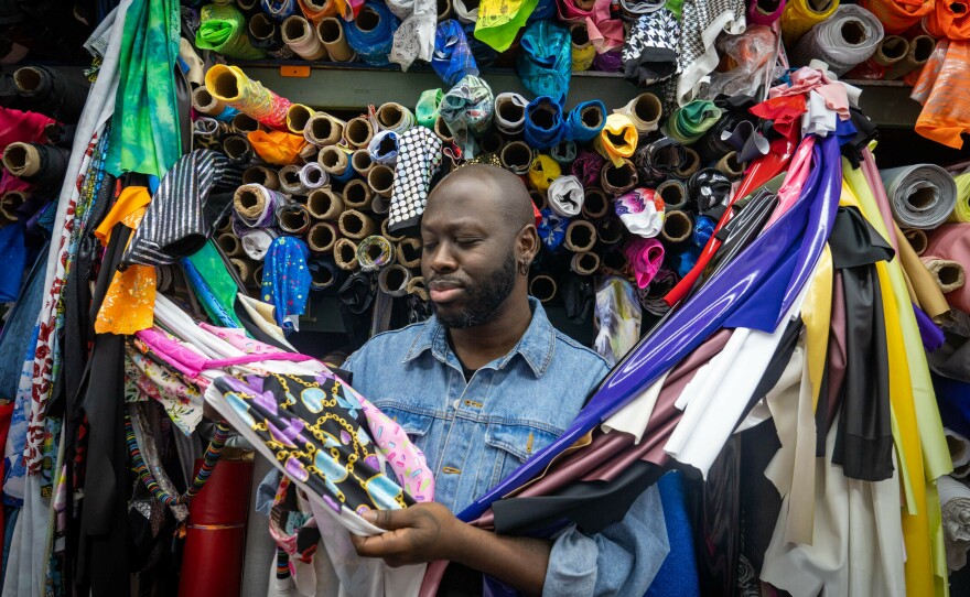 Bob The Drag Queen inspects the fabrics at the Spandex House in New York City.