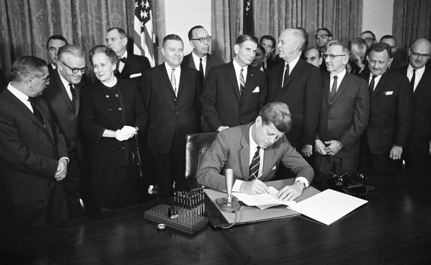 President John F. Kennedy signs the bill intended to shift mental health care from state institutions to the community on Oct. 31, 1963.