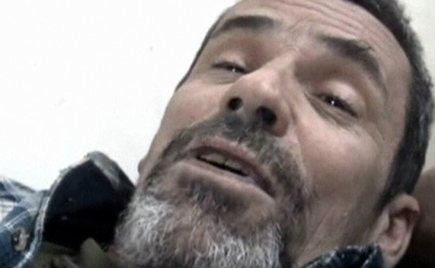British photographer Paul Conroy lies on a stretcher as he is treated by a doctor in Homs on Feb. 22. Avaaz coordinated Conroy's rescue from the embattled city, an operation that left 13 Syrian activists dead.