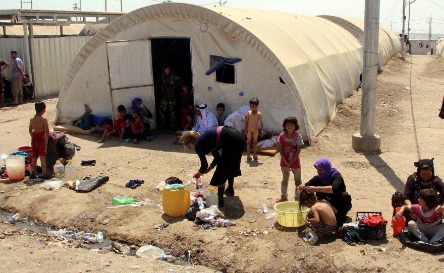 Yazidi women wash their children at a refugee camp near the Iraqi border crossing of Zakho in August.
