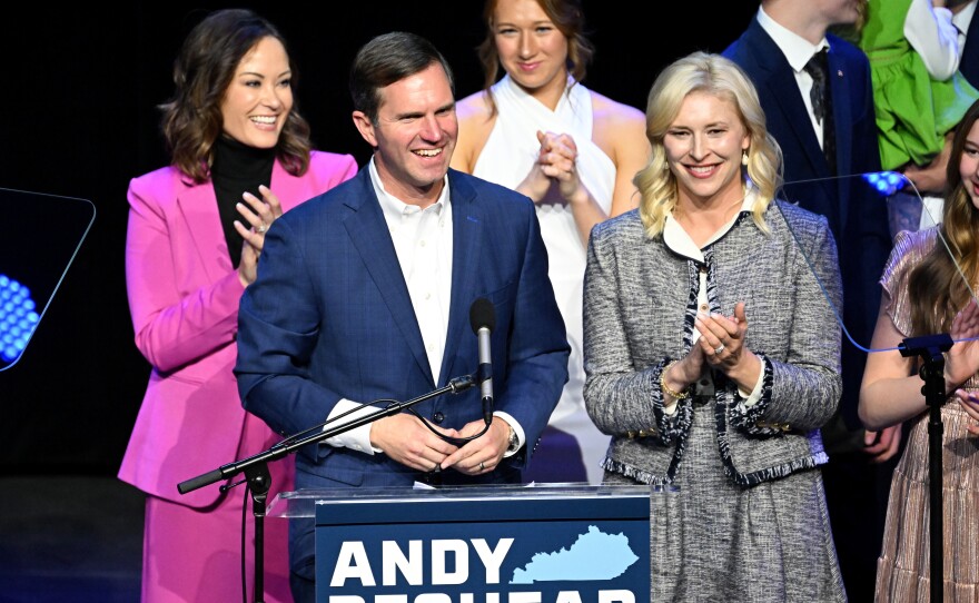 Kentucky incumbent Democratic Gov. Andy Beshear is joined by his wife, Britainy Beshear (R), Kentucky Lt. Governor Jacqueline Coleman (L) and his family as he delivers his victory speech in Louisville on Tuesday.