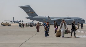Afghan evacuees debark a C-17 Globemaster lll Aug. 23, 2021, at Al Udeid Air Base, Qatar.