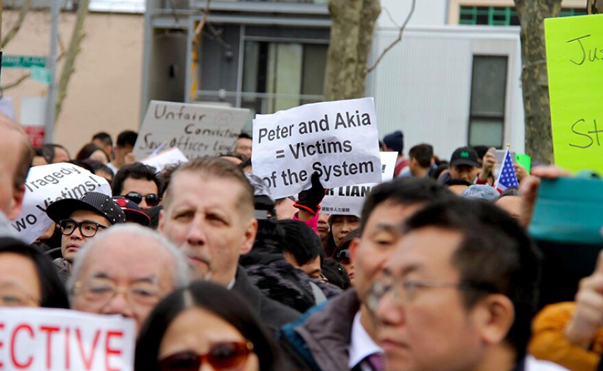 A protestor holds a sign "Peter and Akia Victims of the system" at the Feb. 20, 2016 protest in support of Peter Liang at Cadman Plaza in Brooklyn, NY.