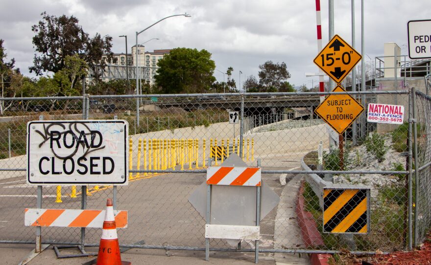 Chain-link fencing and construction signs block vehicular access to the Hazard Center Drive underpass in the Mission Valley neighborhood of San Diego on March 5, 2022.