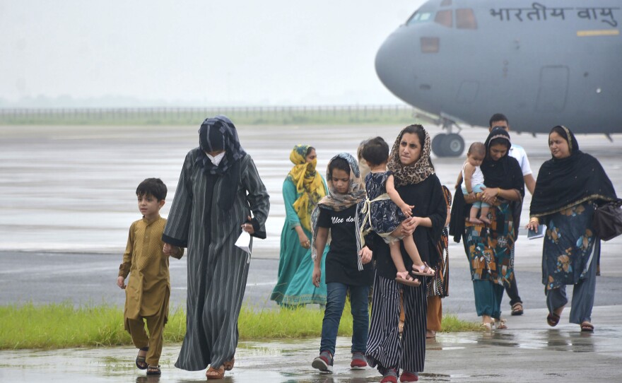 People evacuated from Kabul arrive at Hindon Air force base near New Delhi, on Aug. 22.