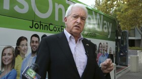 In this Nov. 1, 2018, file photo, Republican gubernatorial candidate John Cox talks to reporters before beginning a statewide bus tour in Sacramento, Calif.