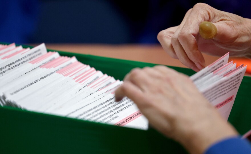 Ballots are processed by an election worker at the Clark County Election Department on in North Las Vegas on Thursday.