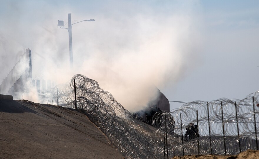 Tear gas thrown by U.S. border agents is seen near the border crossing in Tijuana, Mexico, on Sunday.