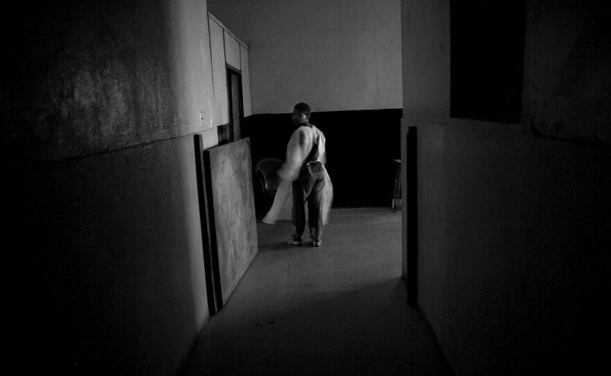 A nurse walks near the empty children's ward at Redemption Hospital in New Kru Town, Monrovia, Liberia.