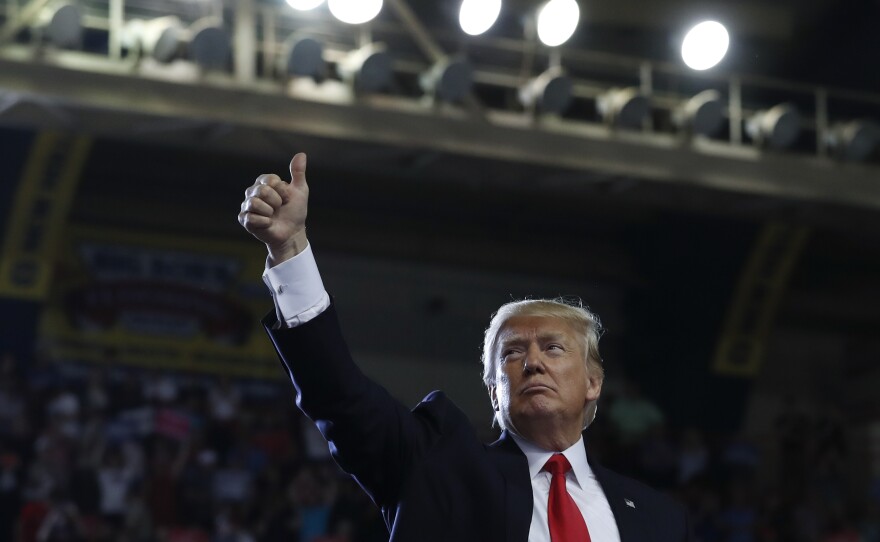 President Donald Trump gives a thumbs-up to the audience behind him as he finishes speaking in Harrisburg, Pa., on Saturday.