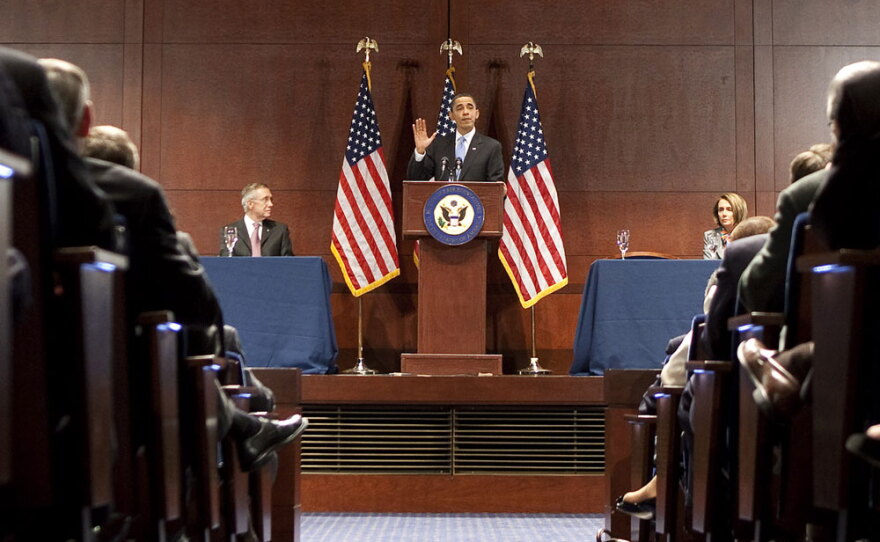 President Obama, flanked by Senate Majority Leader Harry Reid (left) and House Speaker Nancy Pelosi, speaks to the House Democratic Caucus about the need to pass health care legislation.