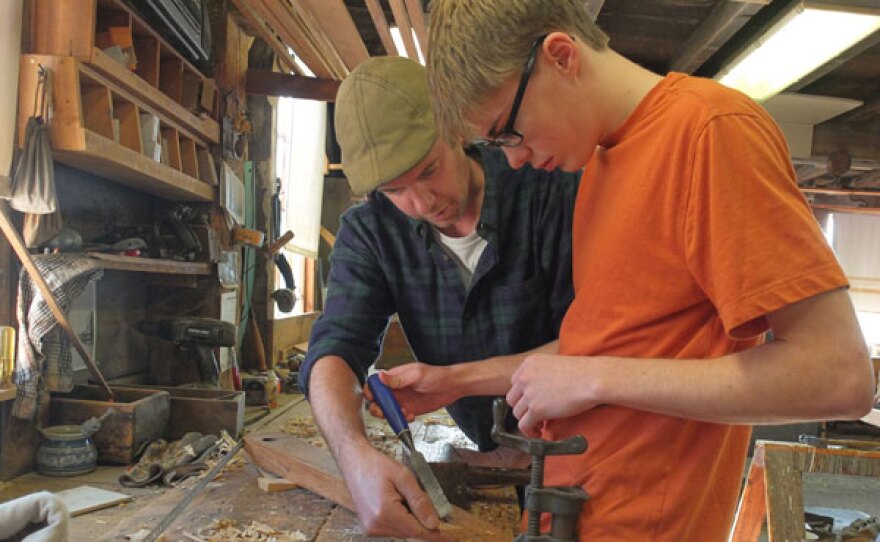 Boat builder Jeffrey Lane works with apprentice Graeme Potter at Lowell’s Boat Shop.