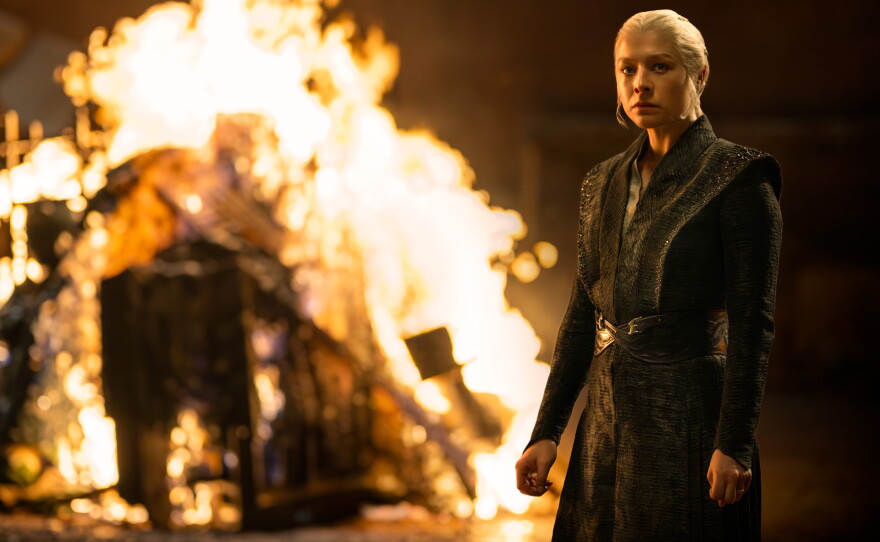 Rhaenyra (Emma D'Arcy) touches the fire and it freezes her/She looks into it and it's Black.