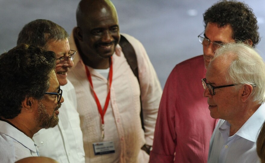 Aronson (on the right in white shirt) speaks with members of the FARC guerrillas during negotiations between the government and the rebels in Havana, Cuba, on Nov. 19, 2015.