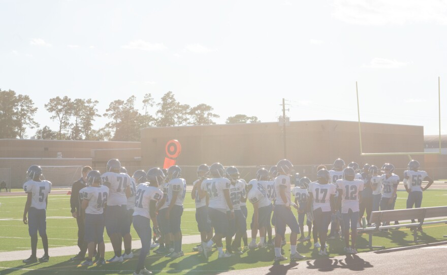 Football players gather at C.E. King High School. Perry-Evans' younger son is on the team. After the family was displaced by the flood, Perry-Evans needed to use the $2,500 she had received from FEMA for a car because they were living more than 45 minutes away.