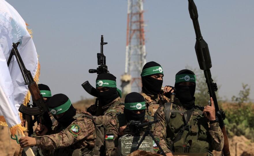 Palestinian fighters of the al-Qassam Brigades, the armed wing of the Hamas movement, march in a military parade to mark the anniversary of the 2014 war with Israel, near the border in the central Gaza Strip on July 19, 2023.