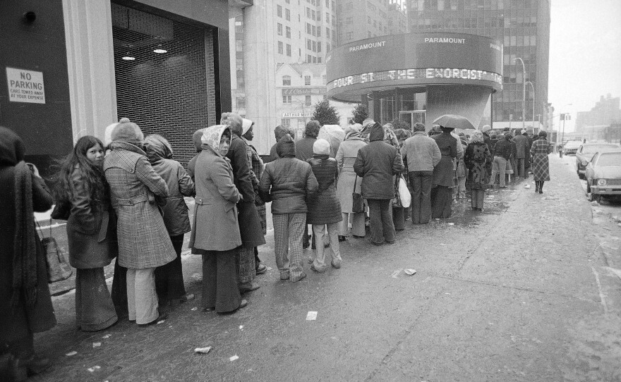 Despite sub-freezing temperatures and rain, a crowd waits in line outside the Paramount Theater in New York City for a showing of The Exorcist in February 1974.