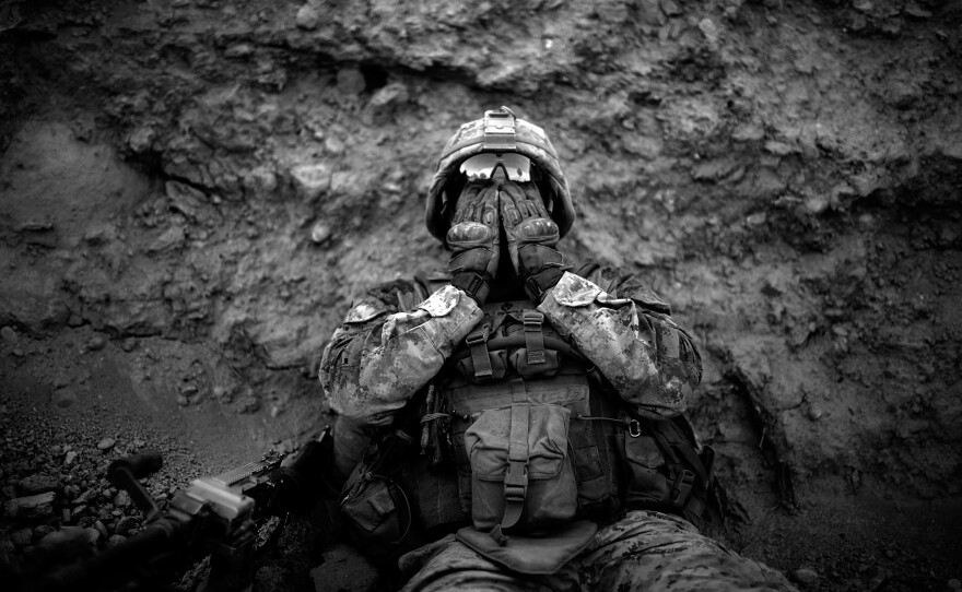 Marine Lance Corp. Anthony Espinoza wipes the sweat out of his eyes at the end of a day-long patrol out of the Sangin District in southern, Afghanistan in May 2011.