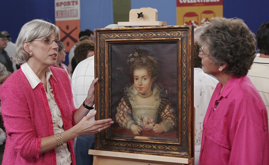 Colleene Fesko (left) appraises a souvenir Frans Pourbus painting, ca. 1850 in Bismarck, N.D. 