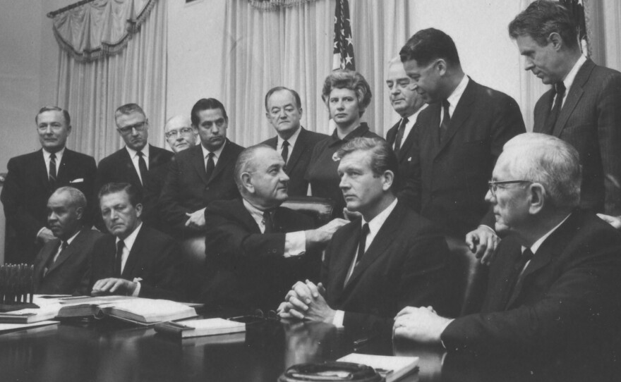 President Lyndon Johnson (seated, center) shakes hands with members of the Kerner Commission. July 29, 1967.