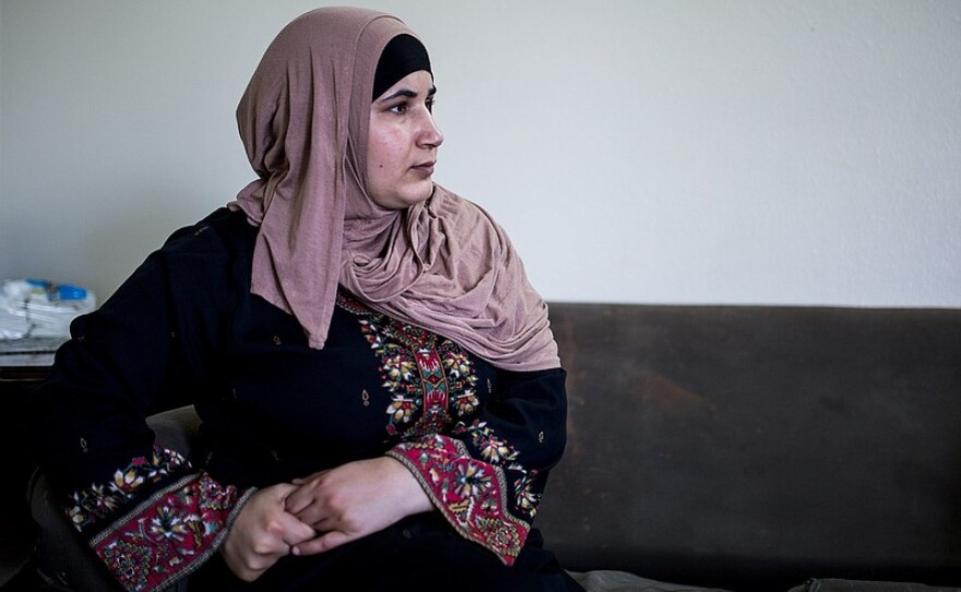 A Syrian refugee sits on a couch in her family's three-bedroom El Cajon apartment, July 25, 2017.