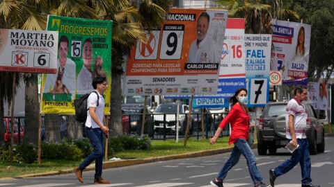 Pedestrians pass election campaign signs for presidential and congressional candidates, before the weekend's election in Lima, Peru, April 10, 2026.