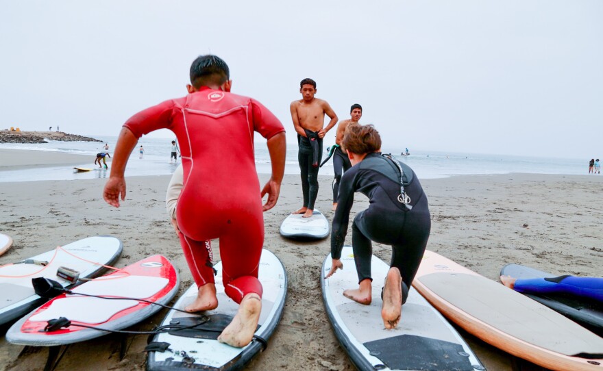 Warm ups on the beach before surfing.