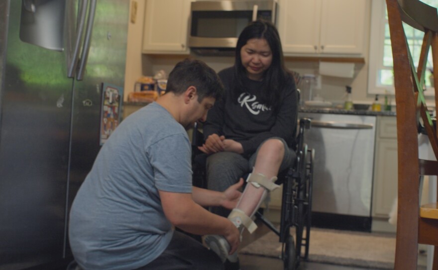 Matt Cauli, caregiver to his wife, Kanlaya, helps her with physical therapy at home while she recovers from a stroke and cancer. Both are featured in "Caregiving."