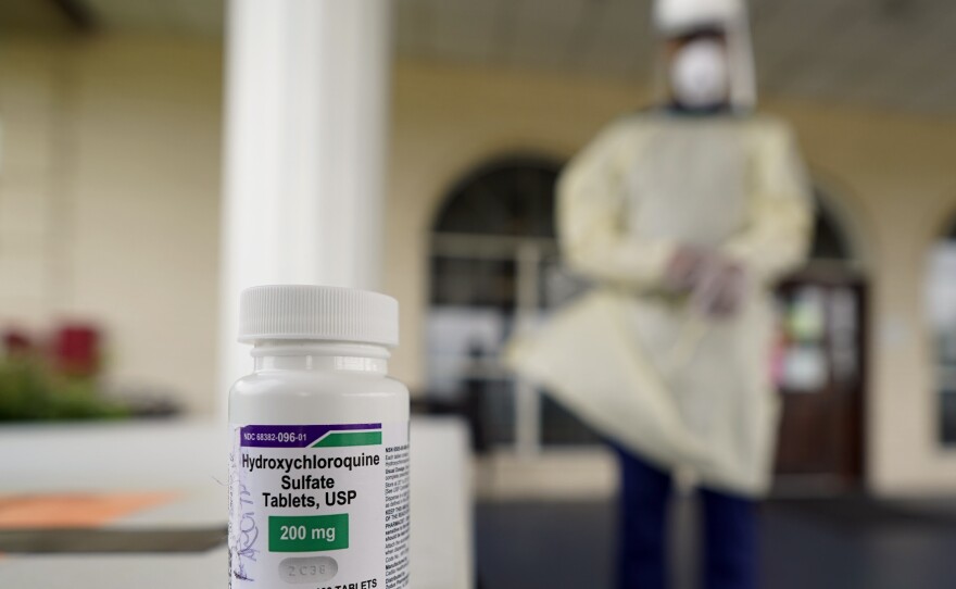 A bottle of hydroxycloroquine sits on a table outside the entrance to The Resort at Texas City nursing home, where Robin Armstrong, a doctor and the home's medical director, is giving the drug to residents