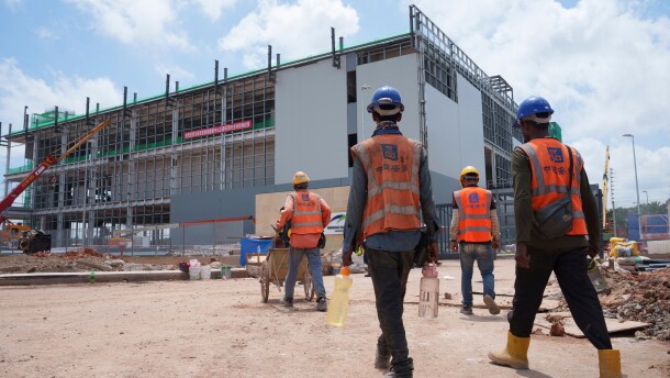 FILE -Construction workers walk to a data center building under construction in Sedenak Tech Park in Johor state of Malaysia, Sept. 27, 2024.