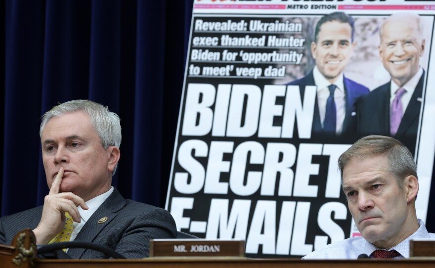 With a poster of a New York Post front page about Hunter Biden on display, House Oversight Committee Chairman Rep. James Comer, R-Ky., and Rep. Jim Jordan, R-Ohio, listen during a Feb. 8 hearing.