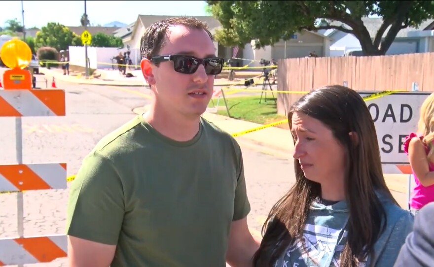 Cody and Courtney Campbell outside their home that was gutted when a Cessna A340 plane crashed into it, Oct. 12, 2021.