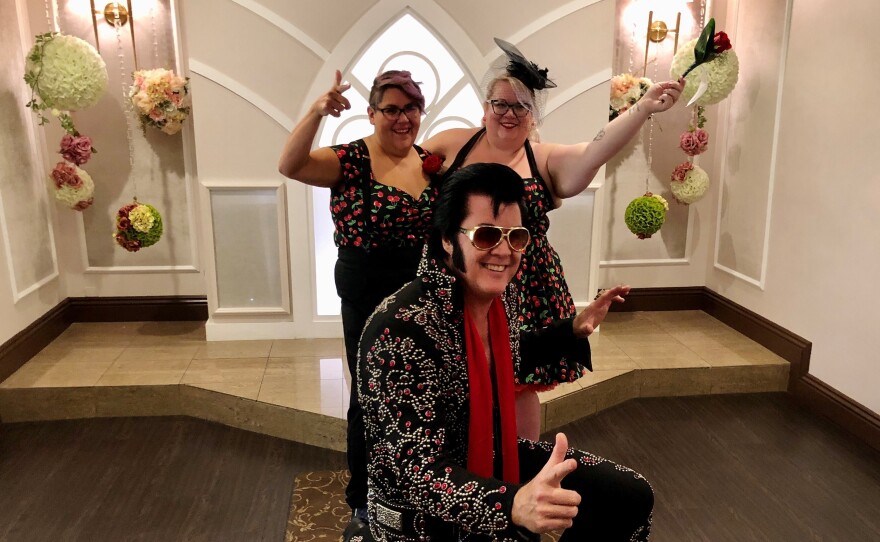 Brendan Paul (center) poses in front of newlyweds Jess Sandoval and Alana Stroebel at the Graceland wedding chapel in downtown Las Vegas.