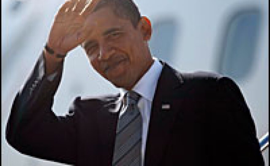 Democratic presidential nominee Barack Obama waves as he walks off his airplane at Chicago Midway International Airport on Tuesday.