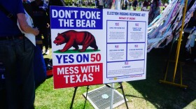 Supporters of a plan to redraw California's congressional districts ahead of the 2026 general election display a sign outside of the San Diego County administration building on Sep. 1, 2025 in San Diego, Calif.