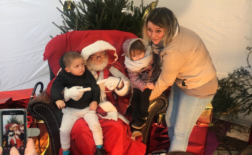 Haley, as Pere Noel, sits with children on his lap. He says that when he walks along the streets in Paris — or anywhere, for that matter — "kids will all of a sudden stop in their tracks like they see Santa Claus."