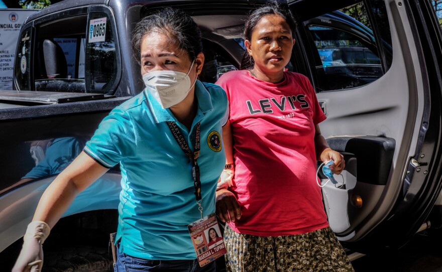 Marissa Tuping, a rural midwife, and Risa Calibuso, right, arrive in Nueva Vizcaya Provincial Hospital on July 21. Calibuso gave birth to her son moments later.