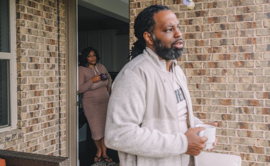 On the left, Iris Garcia watches her husband, Edmund Garcia, listens to a phone call from the Department of Veterans Affairs through his earpiece concerning his financial situation about his home.