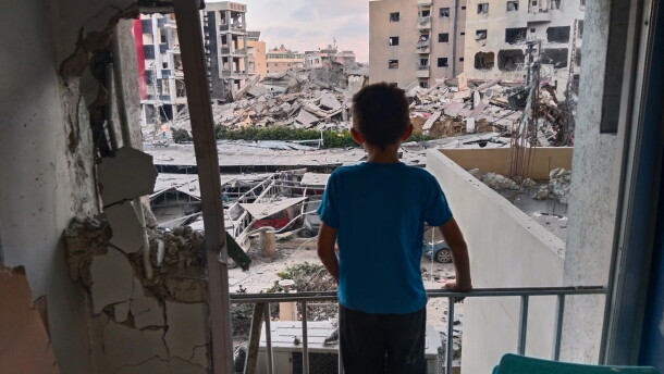 A boy looks through a damaged room of the Jabal Amel Hospital into a destroyed building that was hit in an Israeli airstrike in the southern port city of Tyre, Lebanon, June 1, 2026.