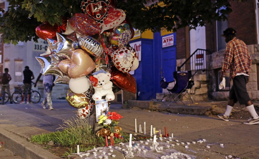 The homicide rate in Baltimore is now at its highest rate, surpassing the 1993 level. Here, balloons and candles mark the spot in the city where a man was shot in July.