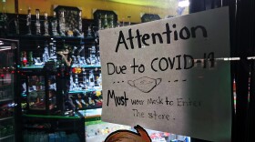 A sign outside of Rock City Smoke Shop in Chula Vista on Nov. 22, 2020, advising customers that masks are required for entering the store.
