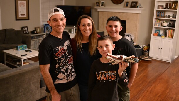 Evan Scheingross, Daniella Knelman and their kids, Riley, 11, and Kaleb, 8, pose for a post-haircut photo in their home on Thursday, Jan. 15, 2026.
