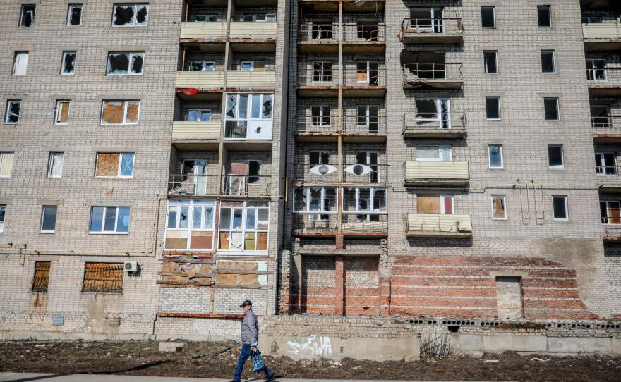 A man walks past an abandoned building in the Donetsk region town of Avdiivka on Feb. 21.