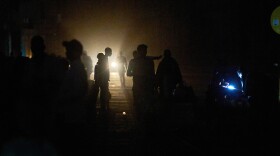 People walk on a street in the dark during a blackout in Havana, Cuba, Saturday, March 21, 2026.
